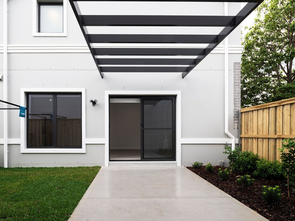 Corner facade showing Juliet balustrades and boundary fencing
